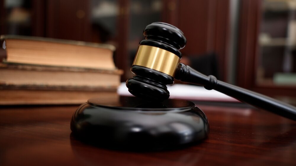 Judge workplace with gavel and books indoors, closeup Justiz
