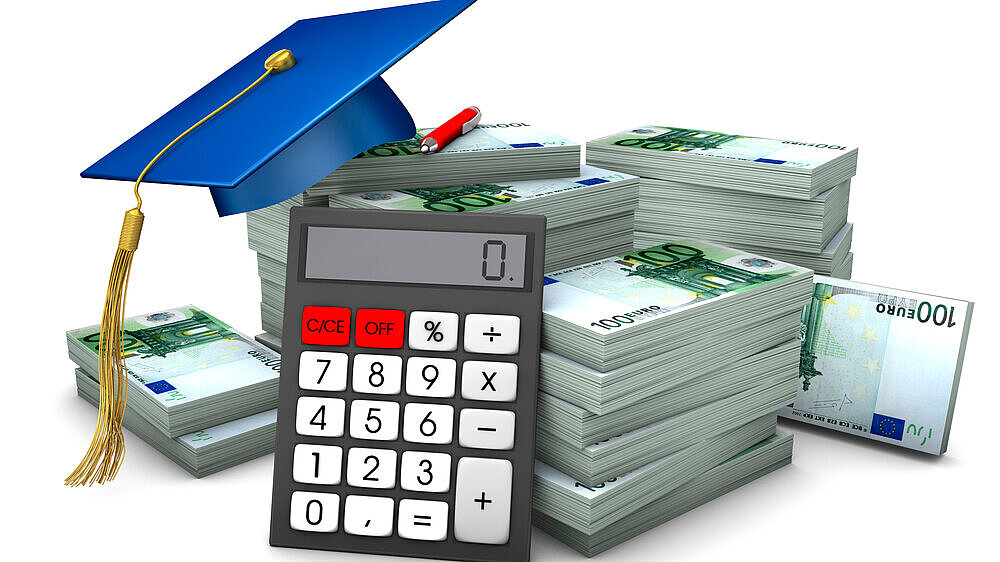 Graduation cap with hundred euro notes and calculator.