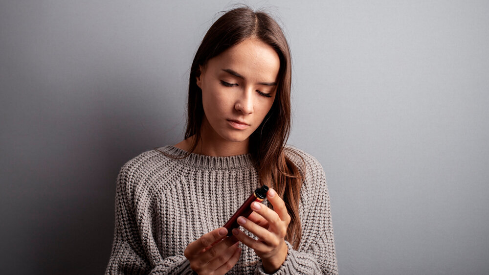 stop vape, refusal of disposable cigarettes, quit smoking teenager, teen girl looks at a ecigarette stop vape, refusal of disposable cigarettes, quit smoking teenager, teen girl looks at a ecigarette
