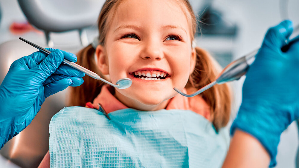 Children's dentistry. Live funny photo of a laughing child at the dentist's appointment.
