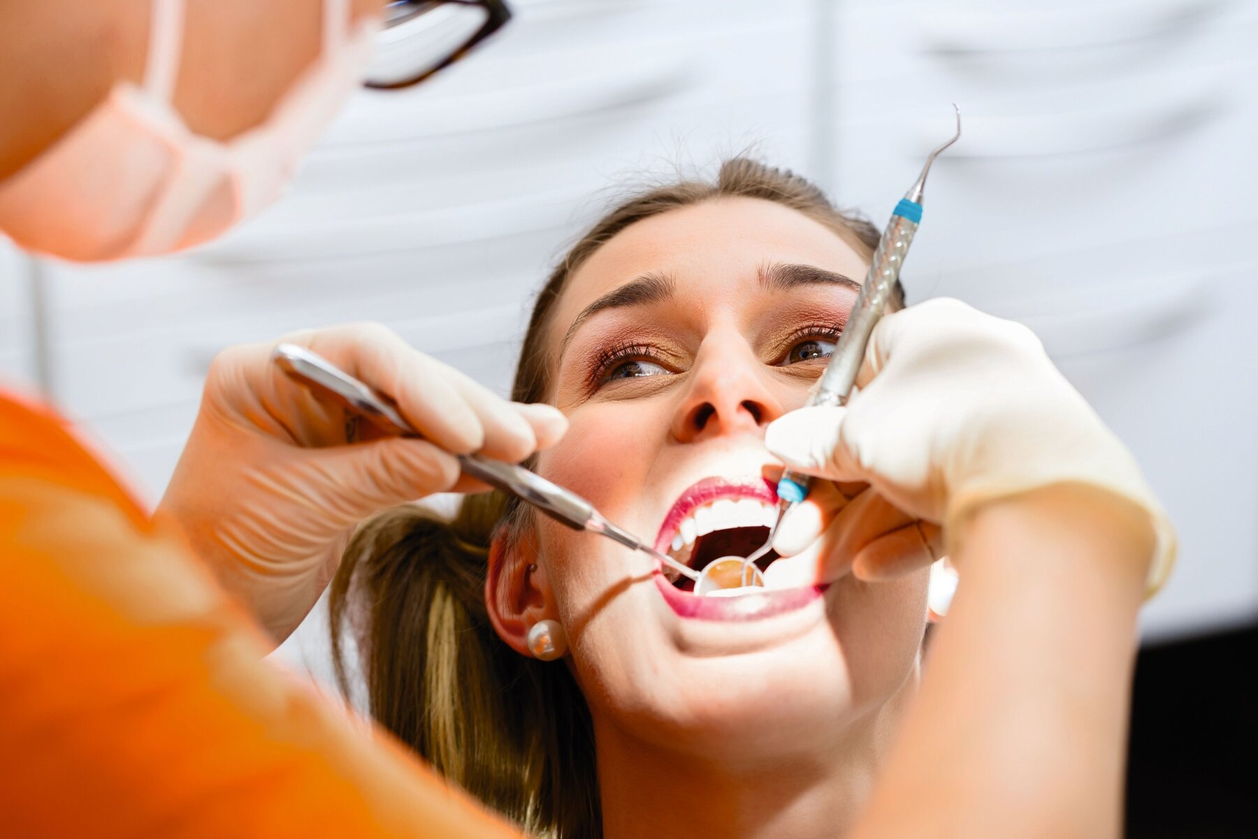 Patient having deep dental tooth cleaning at dentist