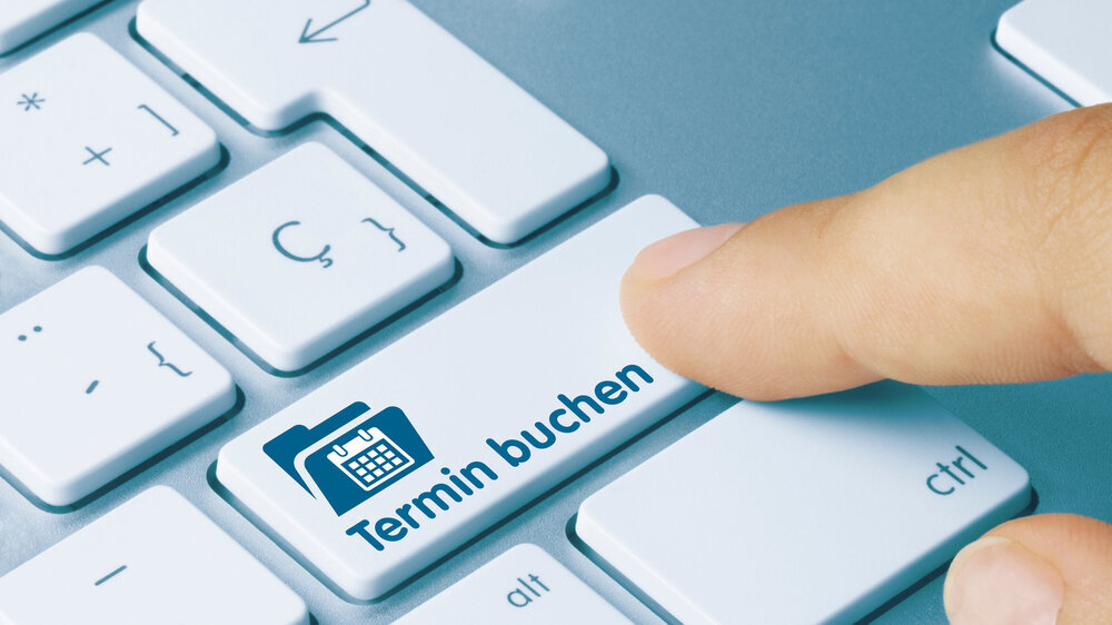 Tastatur mit Schriftzug: Termin buchen.
