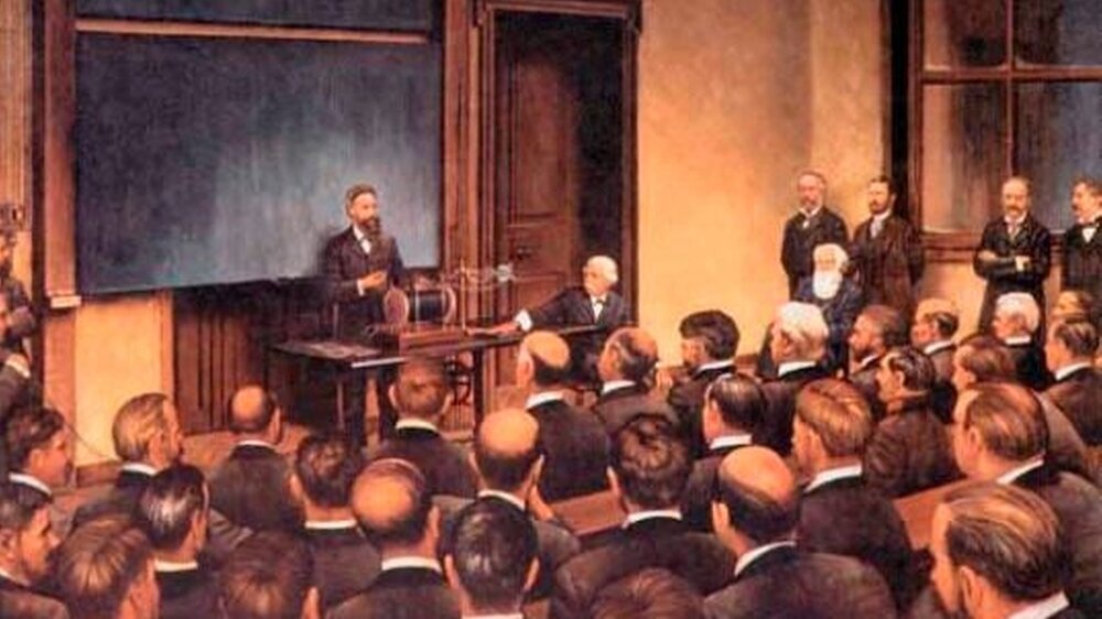 Röntgen demonstriert die X-Strahlen und durchleuchtet die Hand von Anatom Geheimrat Albert Kölliker nach seinem Vortag an der Universität Würzburg am 23. Januar 1896, Gemälde, Maler unbekannt.