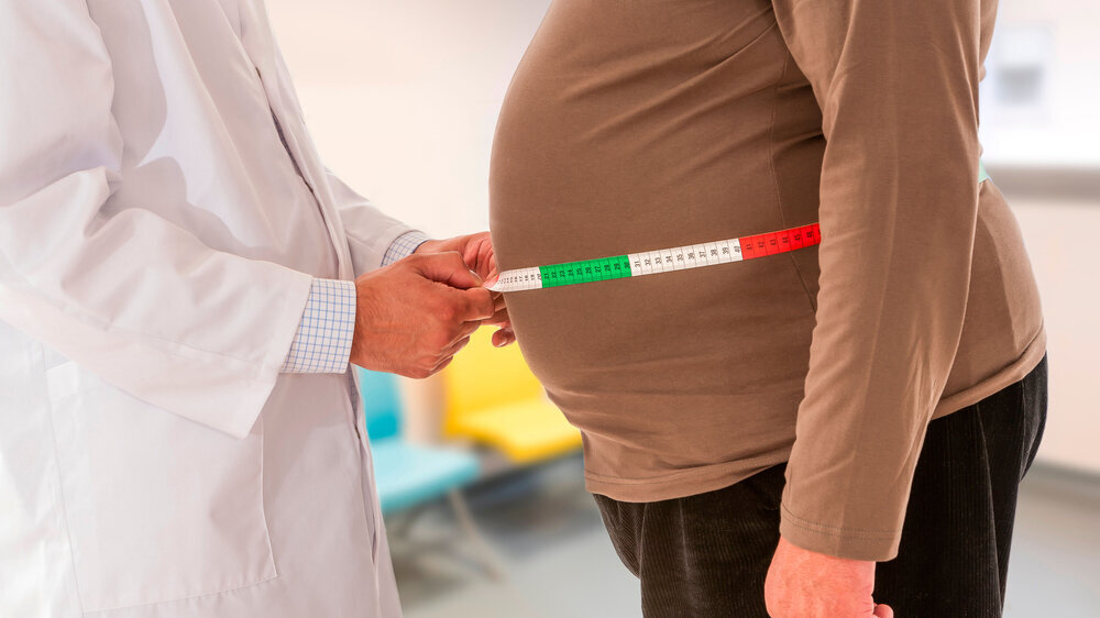 Doctor measuring obese man waist body fat. Obesity and weight loss. Doctor measuring obese man waist body fat. Obesity and weight to loose.