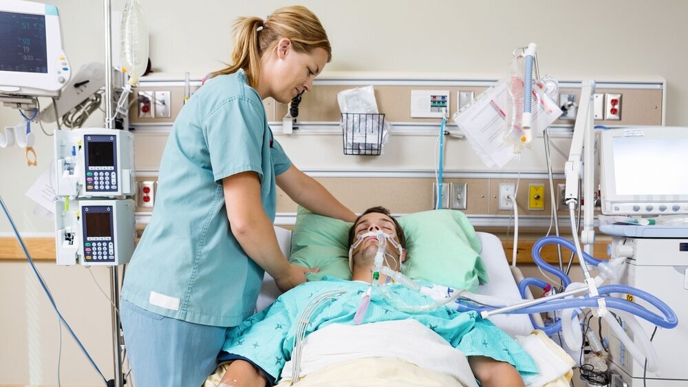 Nurse Adjusting Patient's Pillow KH