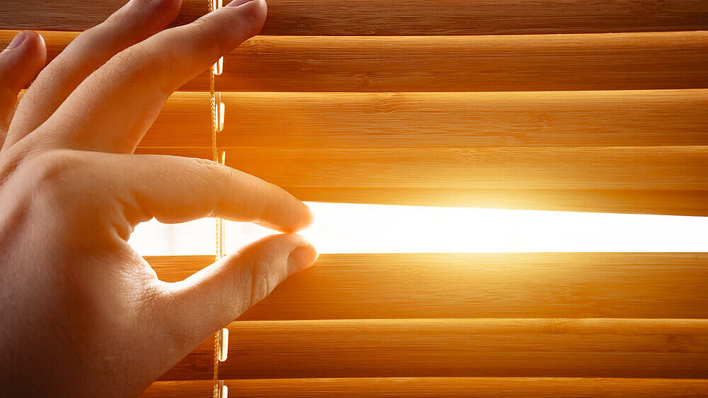 Looking through window blinds, sun light coming inside. Looking through window blinds, sun light coming inside. Conceptual