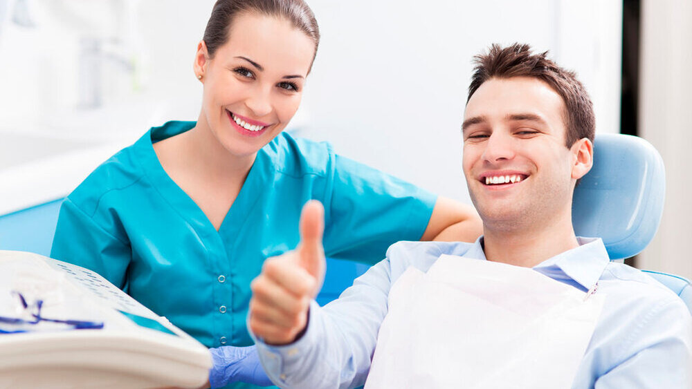 Man giving thumbs up at dentist office