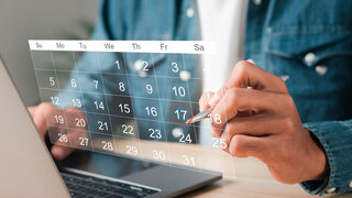 Businessman manages time for effective work. Calendar on the virtual screen interface. Highlight appointment reminders and meeting agenda on the calendar. Time management concept.