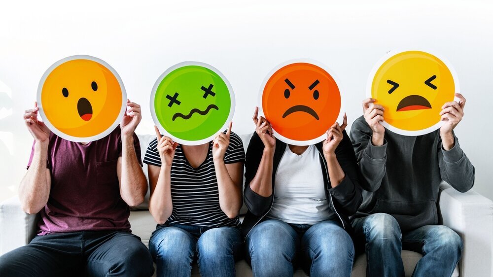 Diverse people holding emoticon Stress Emoticons