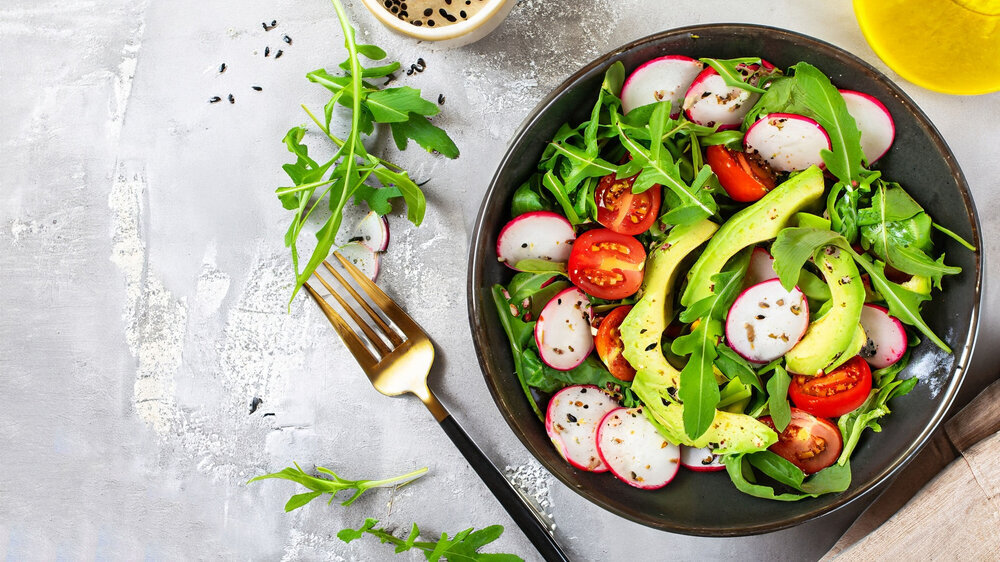 Diet menu. Healthy salad of fresh vegetables - tomatoes, avocado, arugula, radish and seeds on a bowl. Vegan food. Flat lay. Banner. Top view Diet menu. Healthy salad of fresh vegetables - tomatoes, avocado, arugula, radish and seeds on a bowl. Vegan food. Flat lay. Banner. Top view