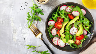 Diet menu. Healthy salad of fresh vegetables - tomatoes, avocado, arugula, radish and seeds on a bowl. Vegan food. Flat lay. Banner. Top view
