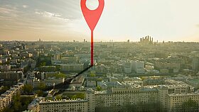 aerial shot of marker pointing on the streets of europe city during sunset