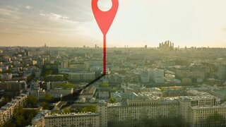 aerial shot of marker pointing on the streets of europe city during sunset