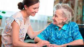 Senior woman with her caregiver at home