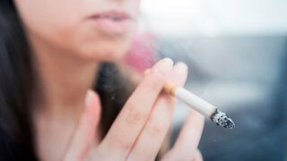 Woman smoking cigarette, unhealthy lifestyle concept, close up