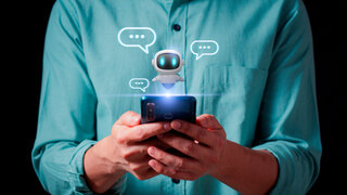 Person using a smartphone to interact with a friendly AI chatbot, and digital chatbot are assistant conversation for provide access to data growth of business in online network.