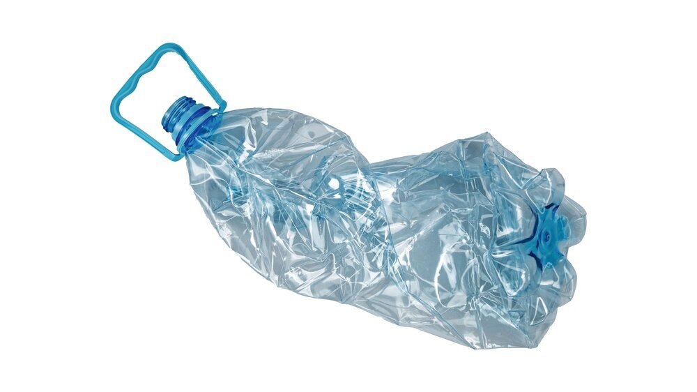 Crushed transparent plastic bottle with a blue handle and cap is isolated. Used PET container prepared for recycling. PET- Plastikflasche