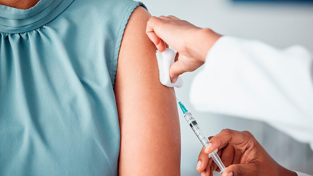 Hands, medical and doctor with patient for vaccine in a clinic for healthcare treatment for prevention. Closeup of a nurse doing a vaccination injection with a needle syringe in a medicare hospital. Hands, medical and doctor with patient for vaccine in a clinic for healthcare treatment for prevention. Closeup of a nurse doing a vaccination injection with a needle syringe in a medicare hospital