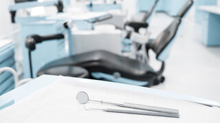 dentist clinic concept with dental tools and dentist chair in background  -