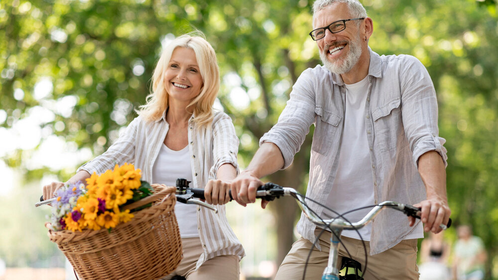 Portrait Of Happy Mature Couple Riding Retro Bicycles In Summer Park Portrait Of Happy Mature Couple Riding Retro Bicycles In Summer Park, Cheerful Senior Spouses Having Fun Together Outdoors, Smiling Elderly Man And Woman Enjoying Free Time On Retirement, Closeup
