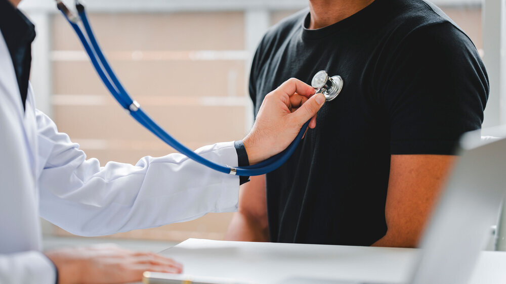 Male patient consulting medical specialist at hospital Chest pain and inflammatory heart disease heart disease care concept Male patient consulting medical specialist at hospital Chest pain and inflammatory heart disease heart disease care concept