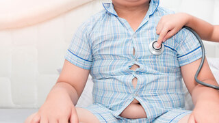 Little hand doctor check heart by stethoscope to obese asian boy, healthcare concept