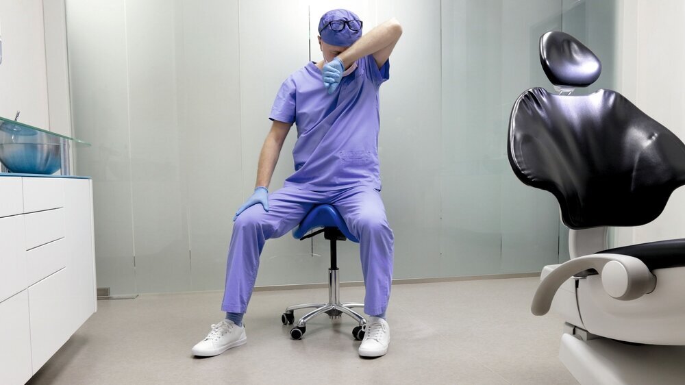 Tired middle age dentist with eyes problem. Having short break for regeneration after long working hours in his office Tired middle age dentist with eyes problem. Having short break for regeneration after long working hours in his office