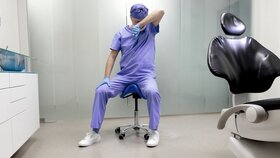 Tired middle age dentist with eyes problem. Having short break for regeneration after long working hours in his office