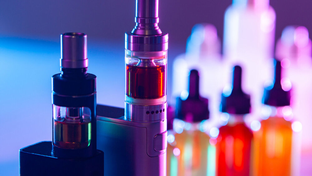Electronic cigarettes on the background of Smoking accessories. Smoking gadgets. E-cigarettes. The concept of vaping. VAPE shop. Sale of accessories for Smoking electronic cigarettes.