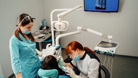 Auszubildende zur Zahnmedizinischen Fachangestellten am Patienten.