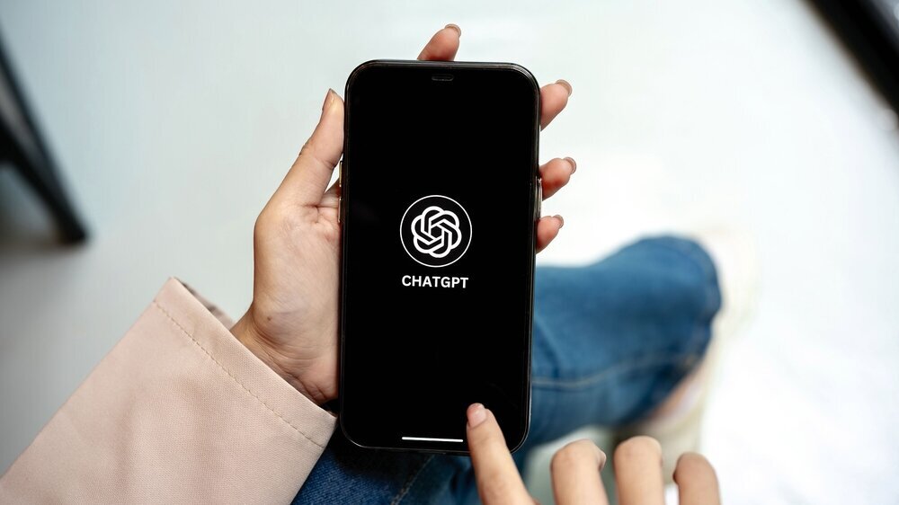 Chiang mai, Thailand - August 28th, 2025: A woman hands holding smartphone open ChatGPT application. Online Assistant, AI Chatbot, Modern Technology.
