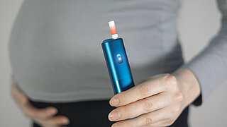 Woman smoking during pregnancy. Danger, unhealthy habit.
