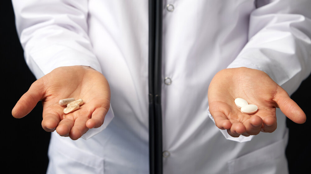 Doctor Hands with Pills. Difficult Choice between drugs. Placebo drugs concept. Healthcare concept.