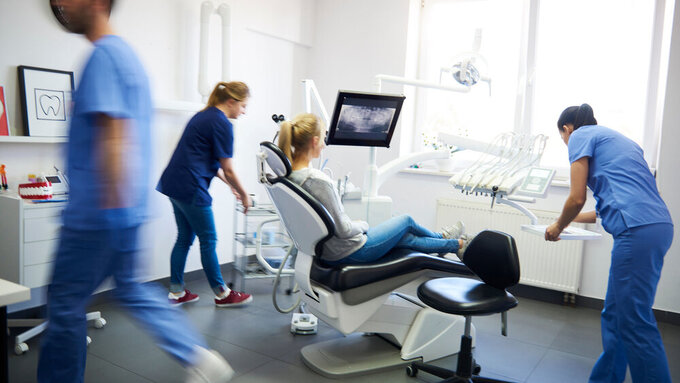 Blurred view of dentists and woman in dentist's Clinic Blurred view of dentists and woman in dentist's Clinic