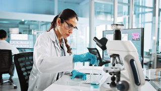 Scientist, woman and research with beaker at lab with sample, liquid and test with pharma career. Person, ppe and equipment with chemical process for medical innovation, vaccine and clinical study.