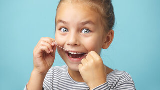 Mädchen mit Zahnseide
