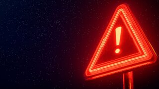 Rotes Neon-Warnschild auf schwarzem Hintergrund