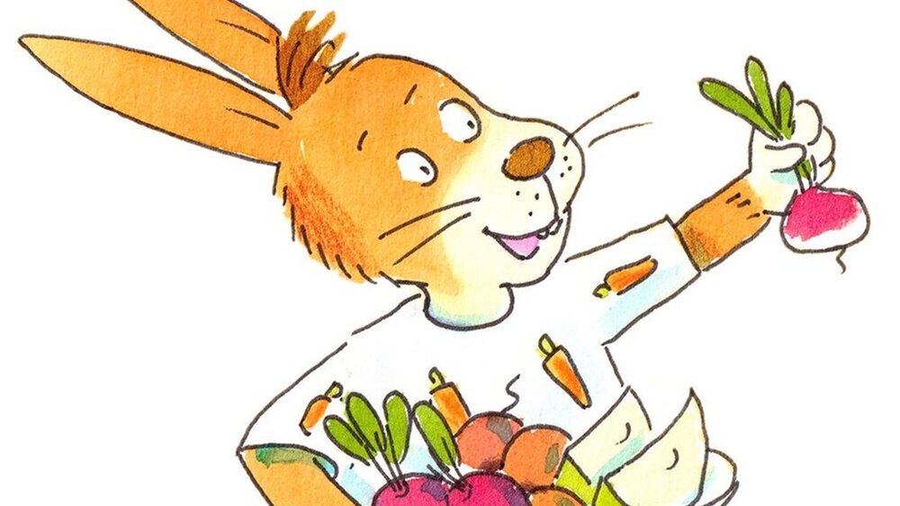 Hörspielfigur Hase Kasimir hält Gemüse und Obst in den Händen