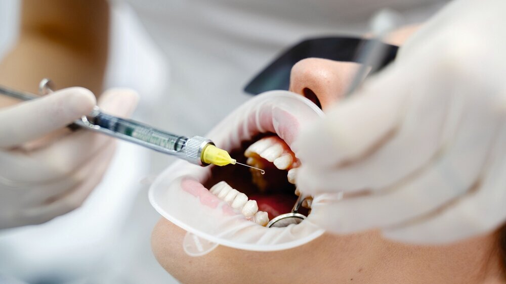 Professional dental local anesthesia for girl before procedure