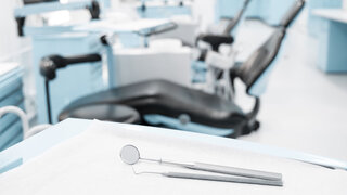 dentist clinic concept with dental tools and dentist chair in background  -