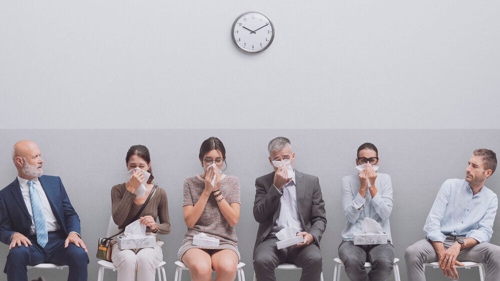 People with cold and flu in the waiting room People with cold and flu blowing nose in the waiting room: coronavirus and social distancing concept