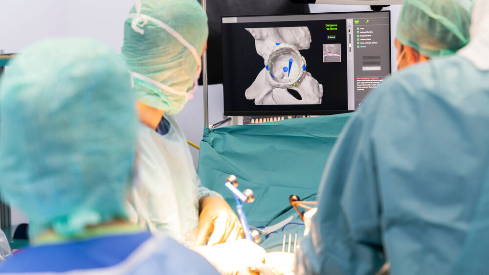 Team of doctor perform total hip arthroplasty replacement surgery in osteoarthritis patient inside the operating room. robot assisted robotic hip and knee replacement surgery