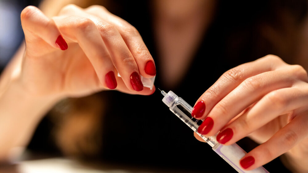 Woman holding an injection pen for diabetic Diabetes