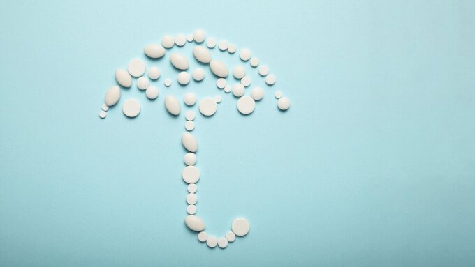 Umbrella of pills, medical insurance. Protection against disease, cancer. Umbrella of pills, medical insurance. Protection against disease, cancer.