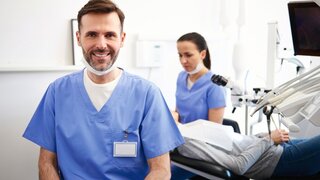 Portrait of smiling male dentist in dentist's clinic