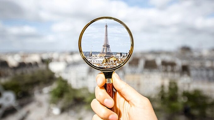 Cityscape view of Paris Looking on the Eiffel tower through the magnifying glass in Paris