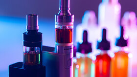 Electronic cigarettes on the background of Smoking accessories. Smoking gadgets. E-cigarettes. The concept of vaping. VAPE shop. Sale of accessories for Smoking electronic cigarettes.