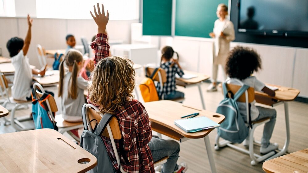 Children at school Back to school. Multiracial pupils of primary school are ready to study. Children in class room with teacher
