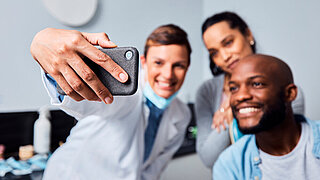 Dentist, couple and selfie with phone for dental wellness, oral hygiene and social media post. Man, women and photography for orthodontics with mobile, gum care or health with happy patient in clinic.