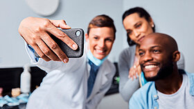 Dentist, couple and selfie with phone for dental wellness, oral hygiene and social media post. Man, women and photography for orthodontics with mobile, gum care or health with happy patient in clinic.